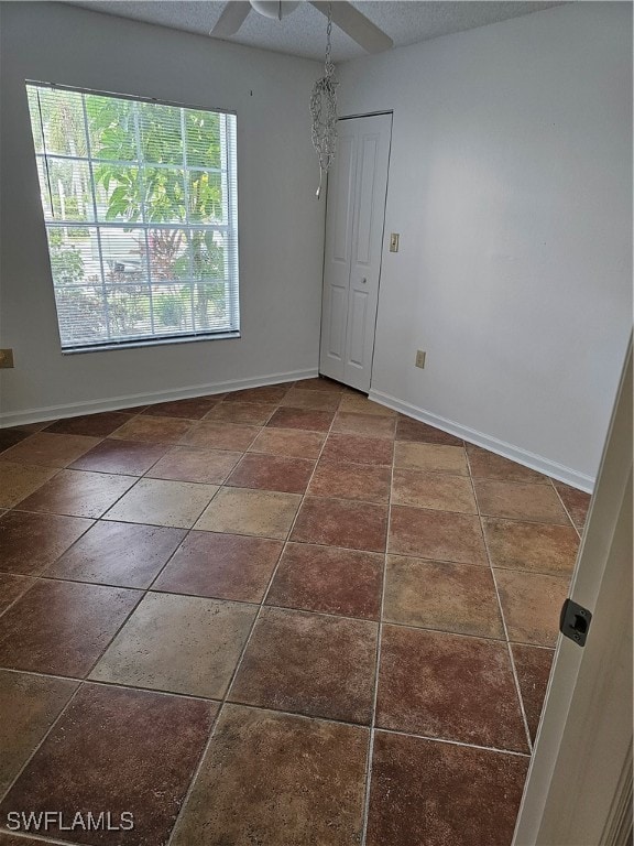 unfurnished room featuring a textured ceiling and ceiling fan