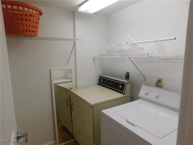 clothes washing area with washer and dryer