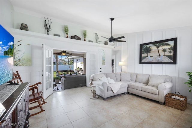 tiled living room featuring french doors and ceiling fan