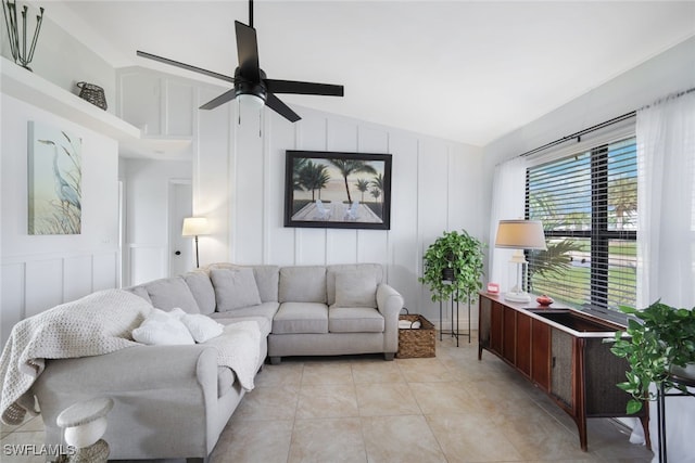 living room with lofted ceiling, light tile patterned flooring, and ceiling fan