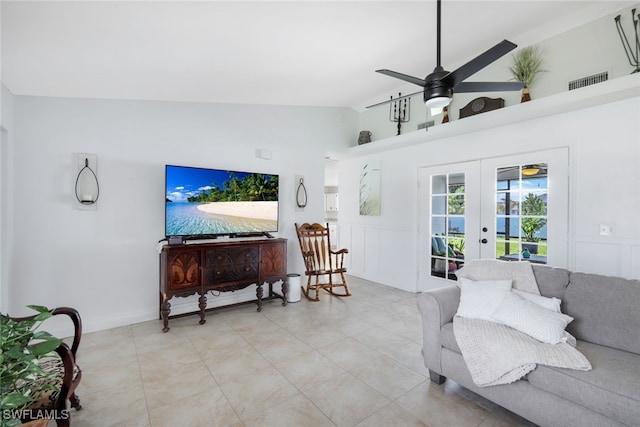 living room with french doors, ceiling fan, and vaulted ceiling