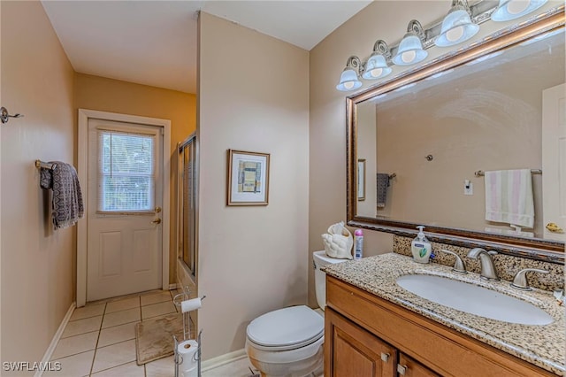 bathroom featuring toilet, vanity, and tile patterned flooring