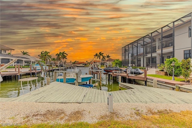 dock area with a water view and glass enclosure