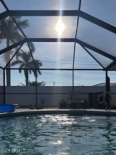 view of pool with glass enclosure