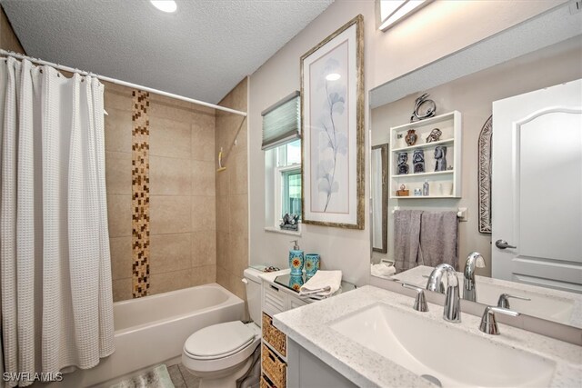 full bathroom featuring a textured ceiling, vanity, shower / bath combination with curtain, and toilet