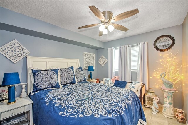 tiled bedroom featuring a textured ceiling and ceiling fan