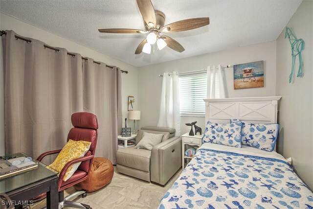 bedroom with a textured ceiling and ceiling fan