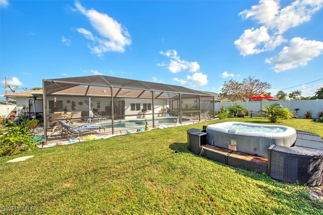 view of yard with a swimming pool with hot tub, glass enclosure, and a patio area