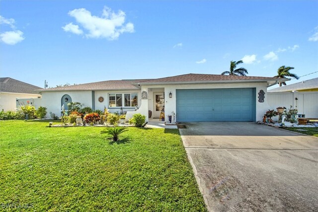 single story home featuring a garage and a front lawn