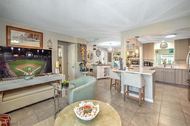 interior space with a textured ceiling and sink