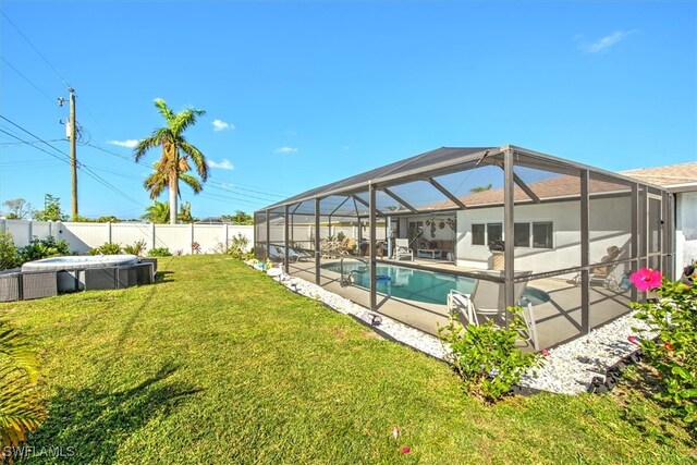 view of swimming pool with a patio, a lawn, and a lanai