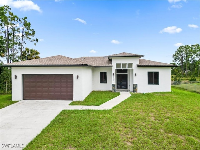 1902 Christopher Ave N, Lehigh Acres, FL 33971 - prairie-style home with stucco siding, a garage, and driveway