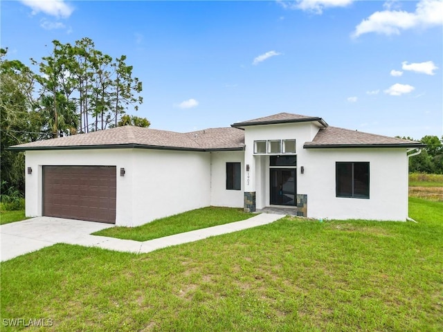 1902 Christopher Ave N, Lehigh Acres, FL 33971 - view of front facade featuring an attached garage, stucco siding, a front lawn, driveway, and roof with shingles