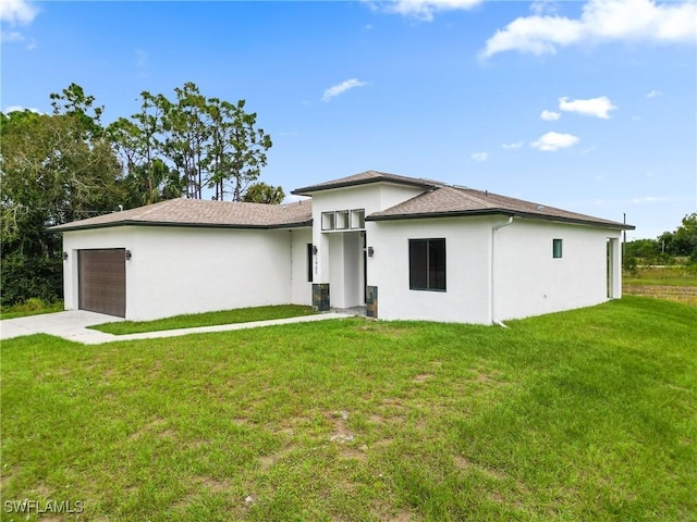1902 Christopher Ave N, Lehigh Acres, FL 33971 - prairie-style home with a garage, stucco siding, a front lawn, and driveway