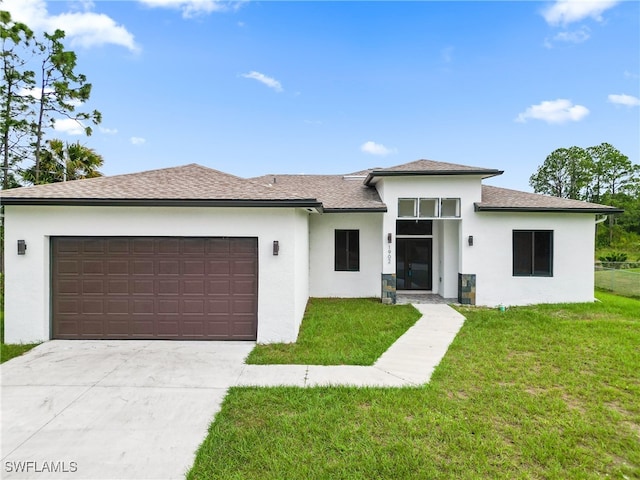 view of front facade with a front lawn and a garage