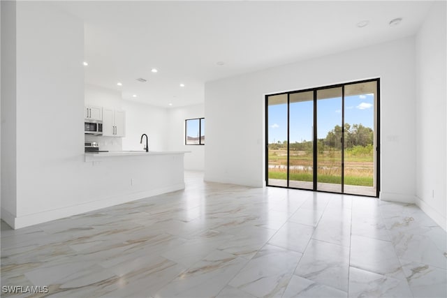 unfurnished living room with sink