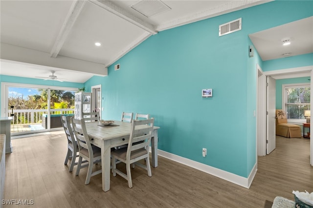 dining space featuring wood-type flooring, lofted ceiling with beams, and ceiling fan