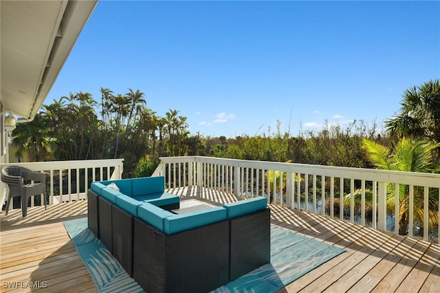 wooden terrace featuring a water view