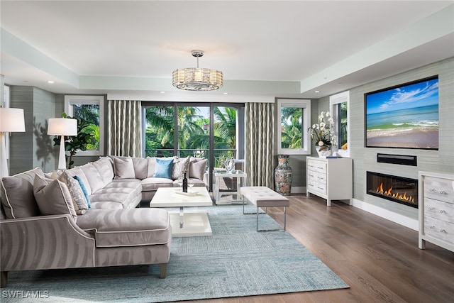 living room with hardwood / wood-style floors and an inviting chandelier