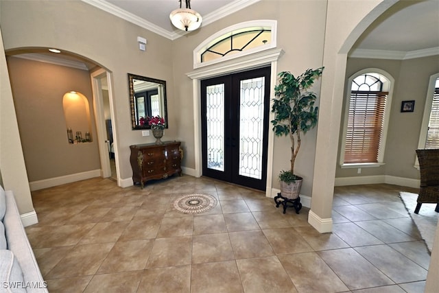 entryway with ornamental molding, french doors, and light tile patterned flooring