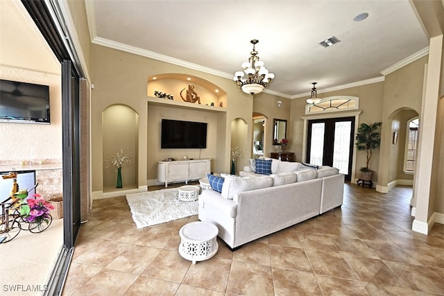 living room with ornamental molding, a chandelier, and light tile patterned floors