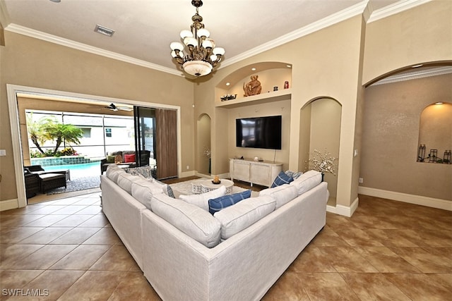 tiled living room with ornamental molding and an inviting chandelier