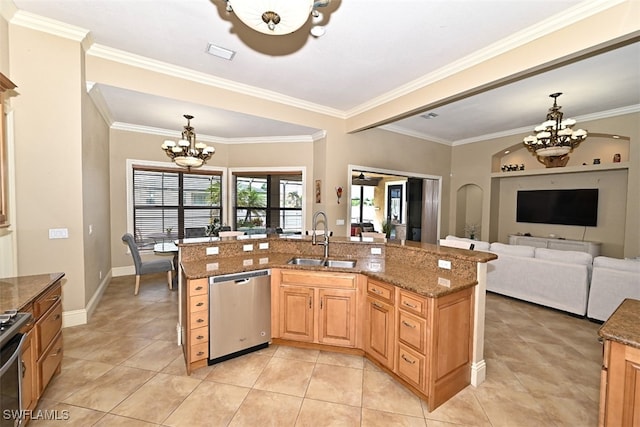 kitchen with appliances with stainless steel finishes, a chandelier, dark stone countertops, ornamental molding, and sink