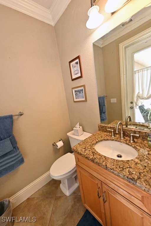 bathroom with toilet, crown molding, vanity, and tile patterned flooring