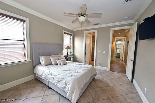 tiled bedroom featuring multiple windows, ornamental molding, and ceiling fan