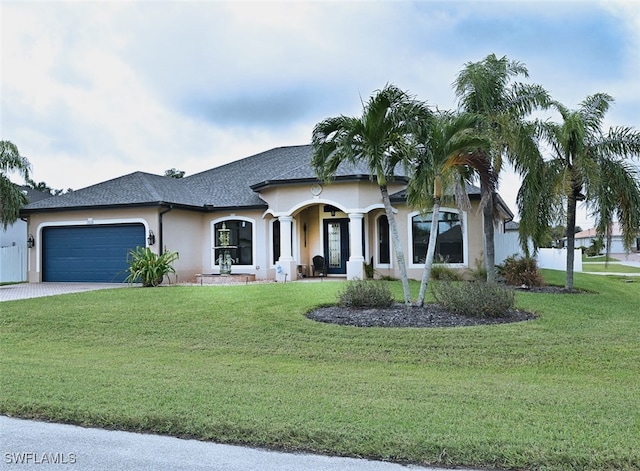 view of front of house featuring a garage and a front lawn