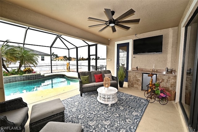 view of patio / terrace with a lanai, outdoor lounge area, a fenced in pool, and ceiling fan