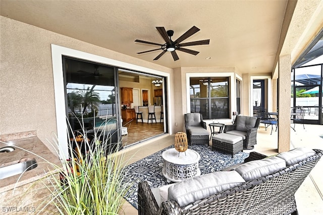 view of patio with a lanai, an outdoor living space, and ceiling fan