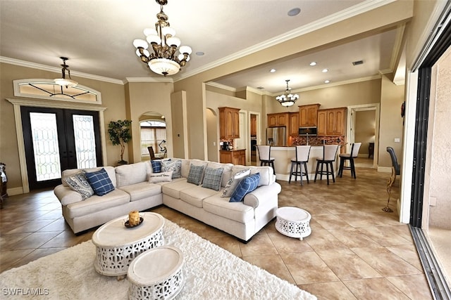 living room featuring an inviting chandelier, french doors, light tile patterned floors, and crown molding