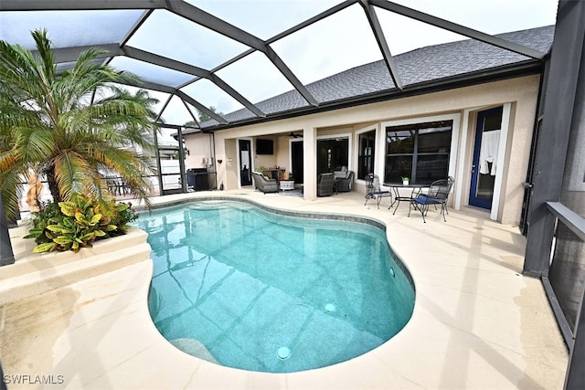 view of swimming pool with a patio and a lanai