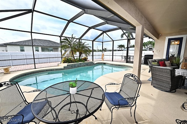 view of swimming pool with a patio area and a lanai