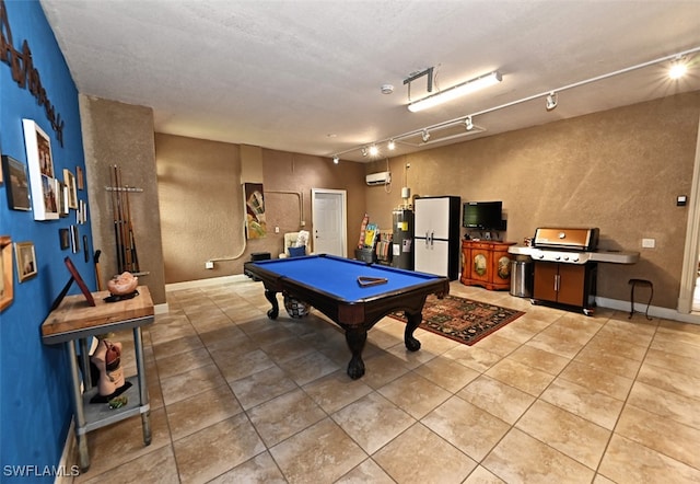 game room featuring tile patterned flooring, rail lighting, billiards, and water heater