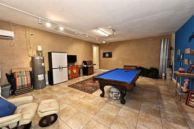 recreation room featuring pool table, rail lighting, a wall mounted air conditioner, water heater, and tile patterned flooring