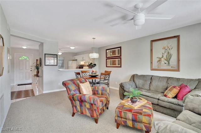 carpeted living room featuring ceiling fan