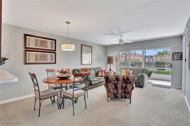 carpeted dining space featuring ceiling fan