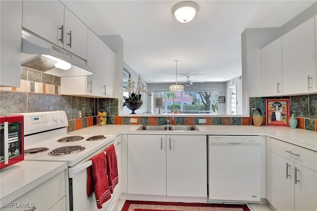 kitchen featuring white cabinetry, sink, decorative backsplash, kitchen peninsula, and white appliances