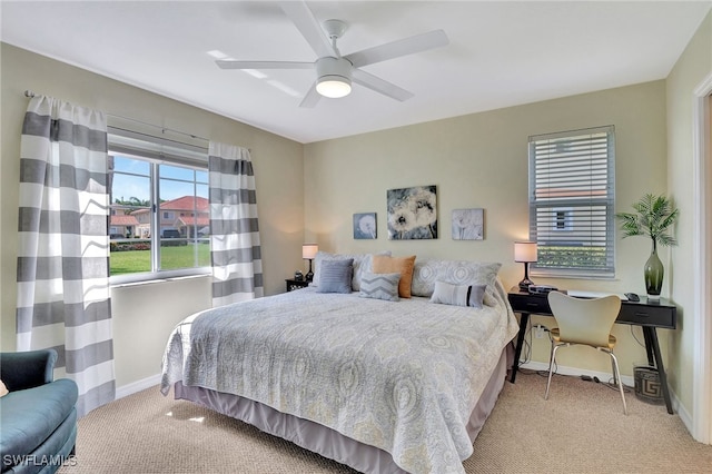 bedroom featuring light colored carpet and ceiling fan