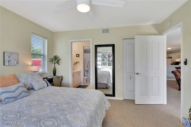 carpeted bedroom featuring connected bathroom and ceiling fan