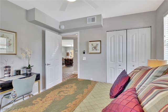 bedroom with ceiling fan and a closet