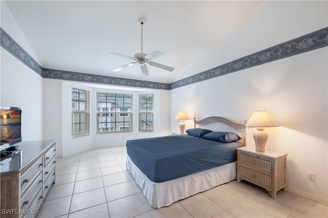 bedroom featuring vaulted ceiling, light tile patterned floors, and ceiling fan