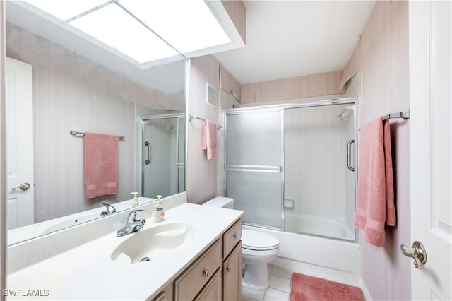 full bathroom with vanity, tile patterned flooring, combined bath / shower with glass door, and toilet