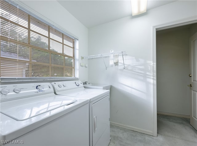 washroom featuring light carpet, sink, and independent washer and dryer