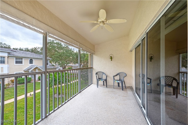 sunroom featuring ceiling fan