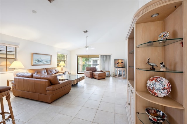 living room with light tile patterned floors, ceiling fan, and vaulted ceiling