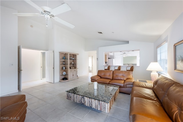 living room featuring vaulted ceiling, light tile patterned floors, and ceiling fan