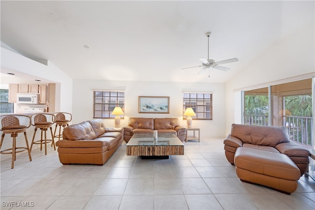 living room featuring high vaulted ceiling, light tile patterned floors, and ceiling fan